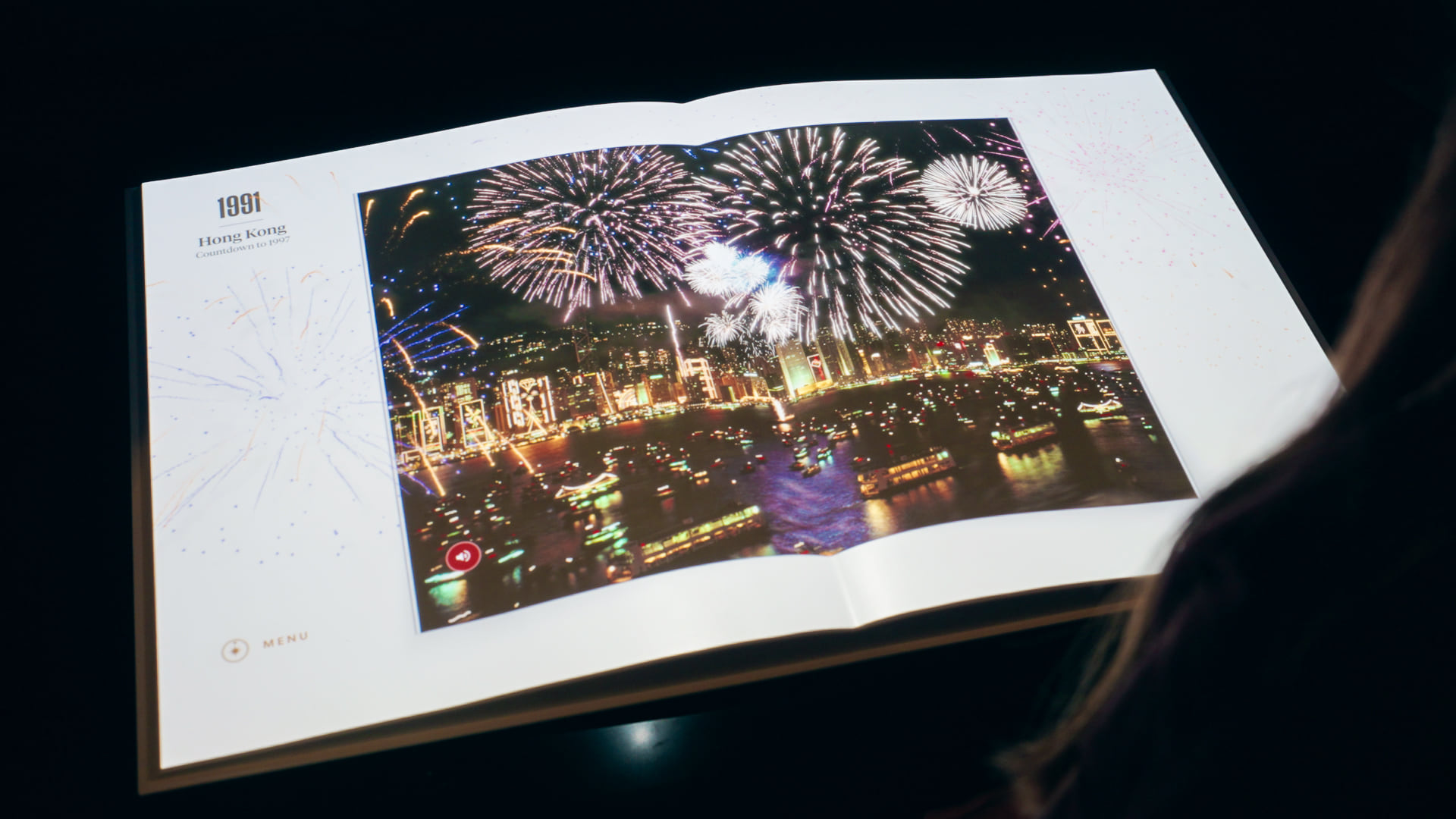 Historic magazine spread featuring fireworks projected across the book